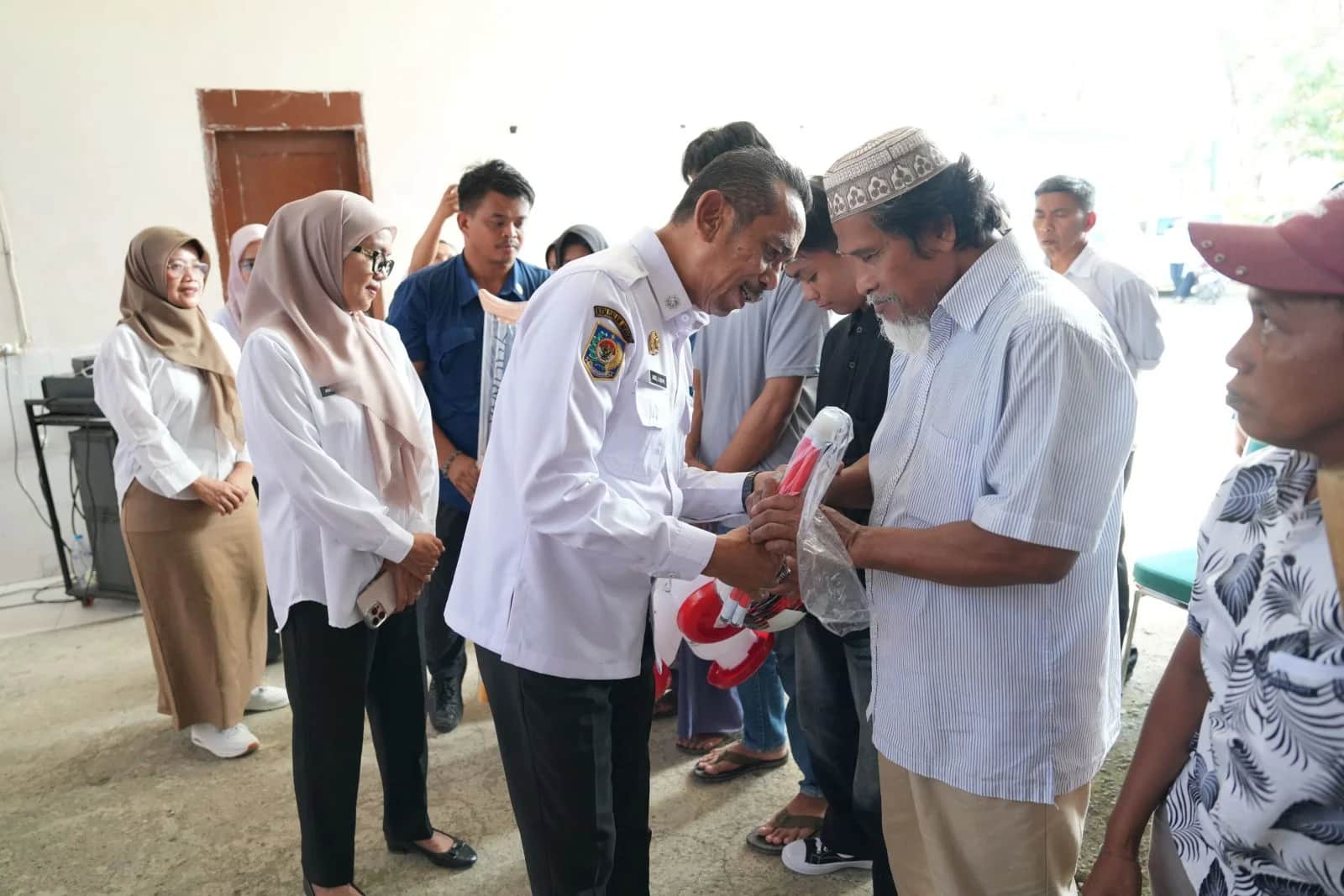 Andi Jefrianto Asapa menyerahkan bantuan ATENSI kepada penerima manfaat di Sinjai